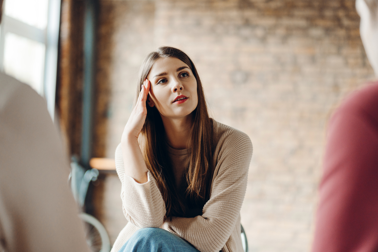 Woman seated in a support group