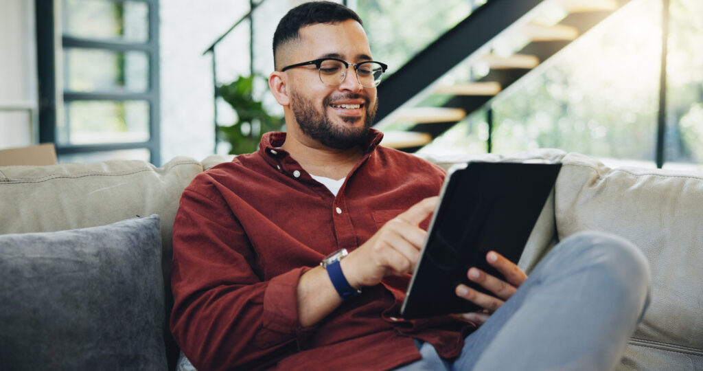 Man reading newsletter on tablet