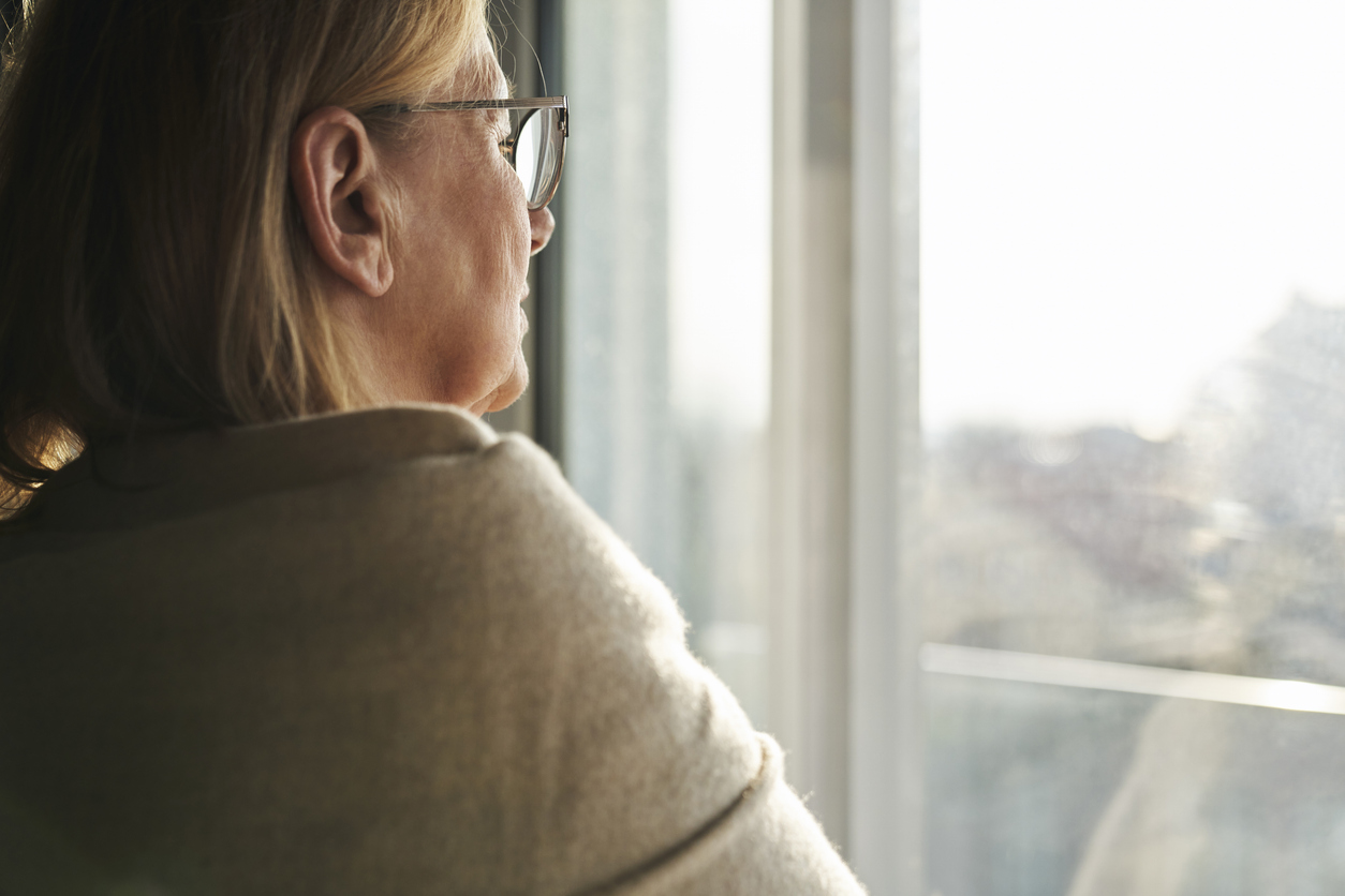 Woman looking through window