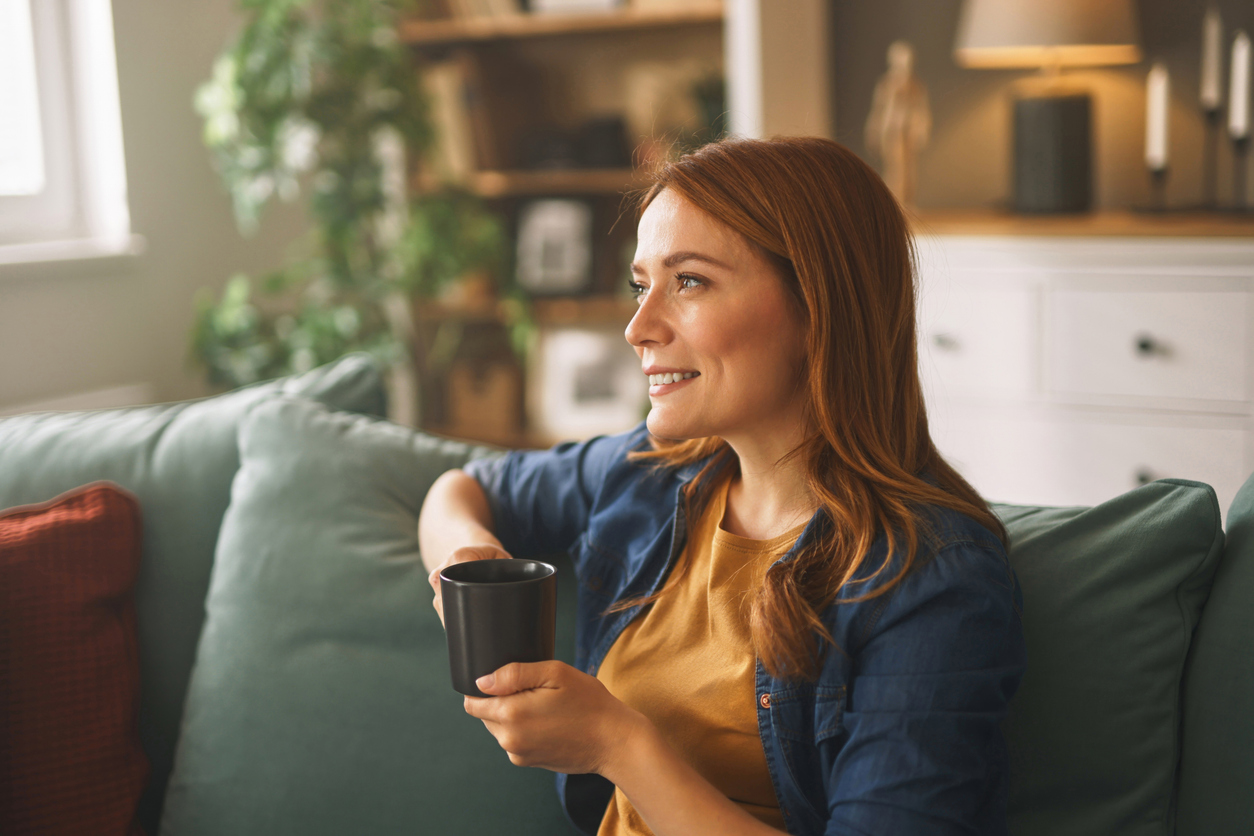 Woman drinking coffee in the morning at her home