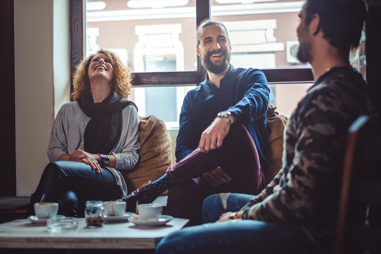 Individuals laughing in a communal space